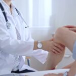 Doctor is carefully examining a patient's knee, providing personalized care and support. Medicine and orthopedic concept