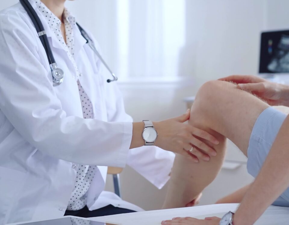 Doctor is carefully examining a patient's knee, providing personalized care and support. Medicine and orthopedic concept